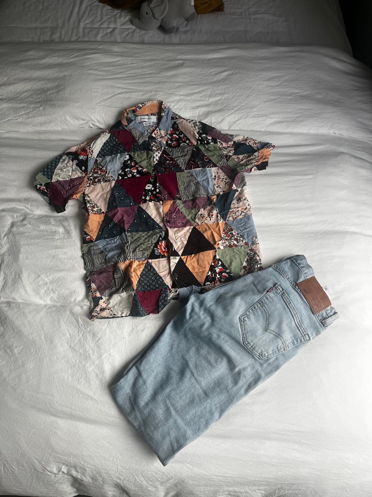 an oufit laid out on a bed