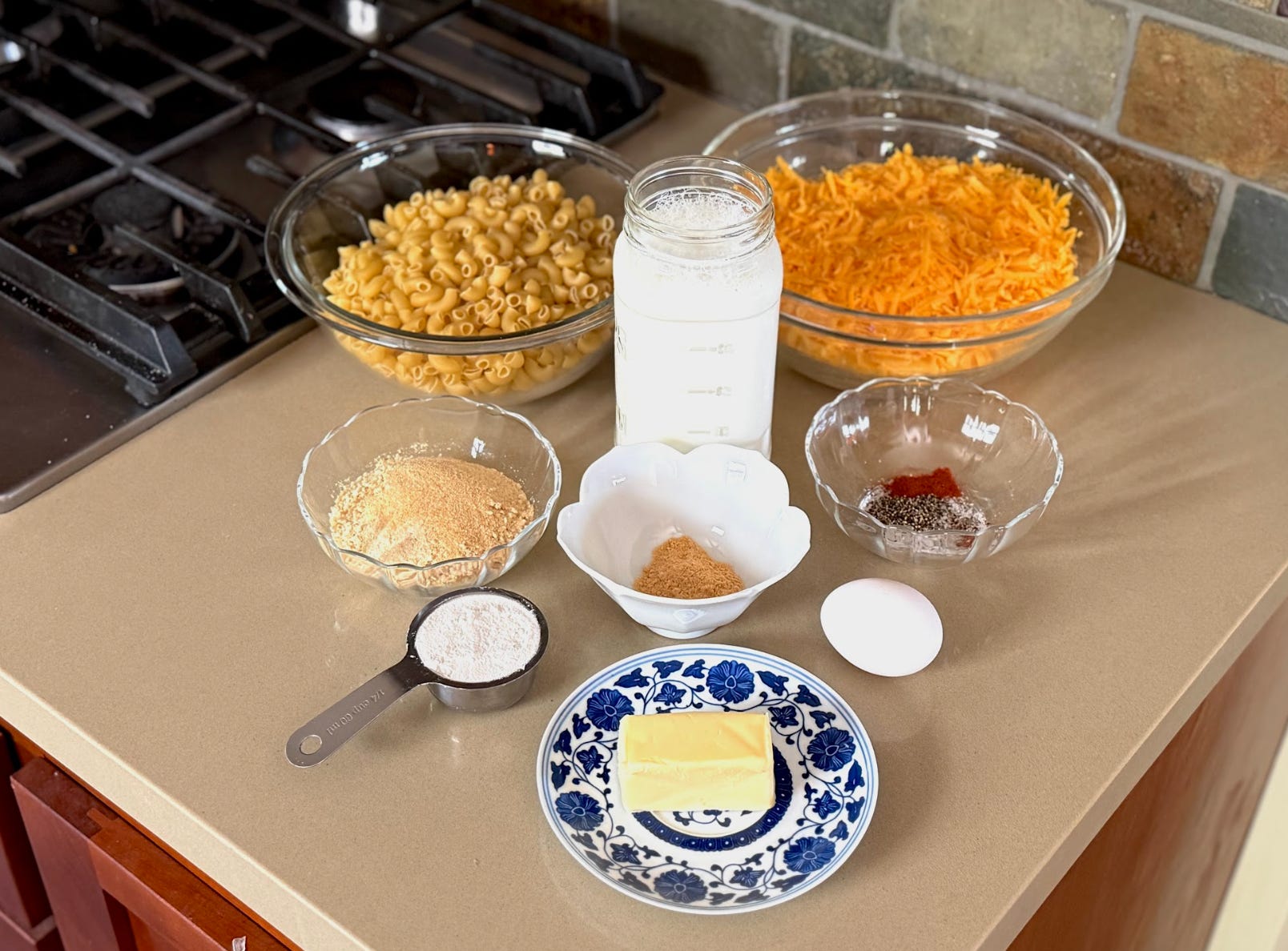 The ingredients for Ree Drummond's mac and cheese, including pasta, butter, herbs, and cheddar.