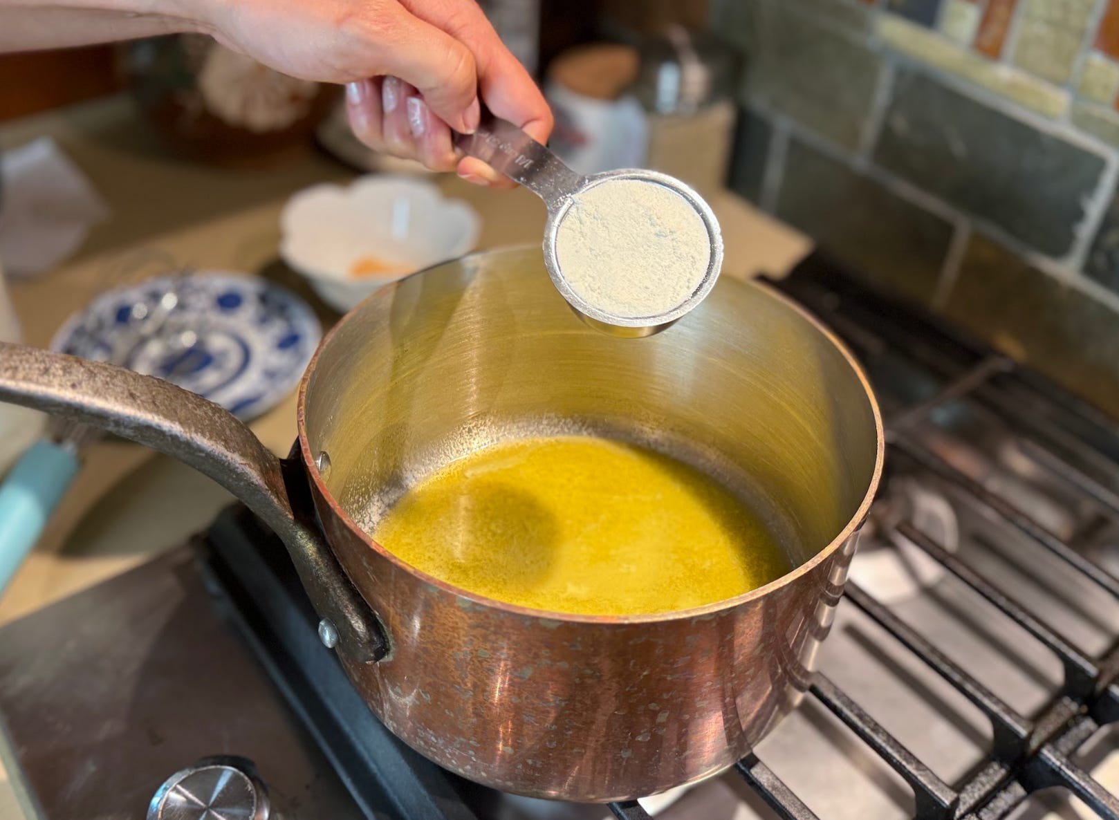Butter and flour mixing together in a roux.