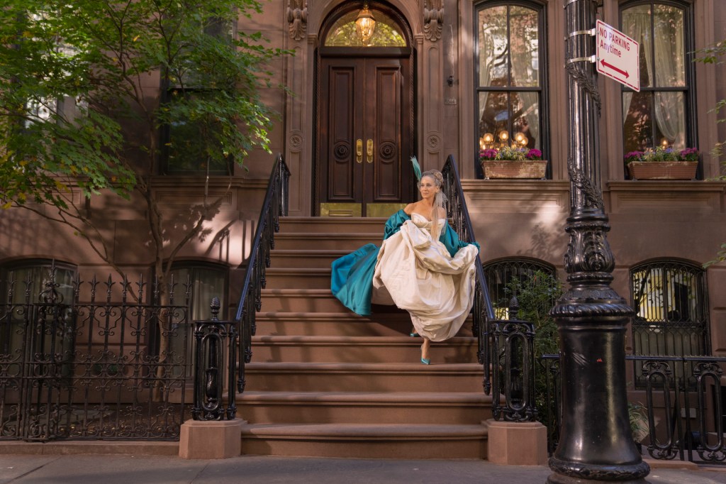 Sarah Jessica Parker as Carrie Bradshaw on West Village apartment stoop