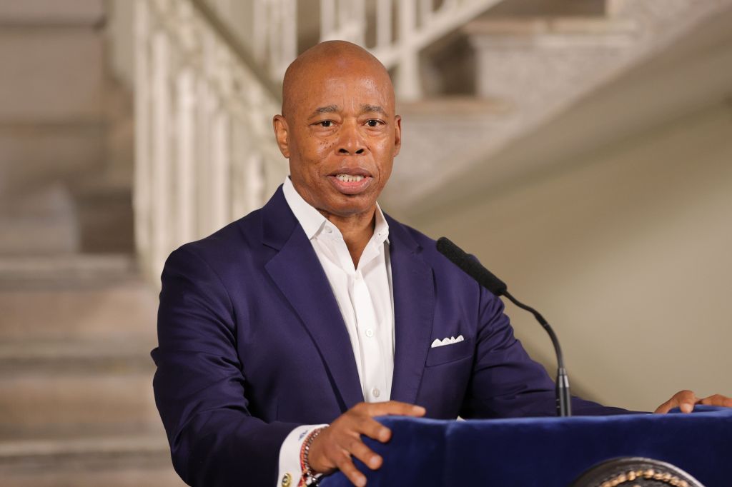 Mayor Eric Adams speaking at a podium.