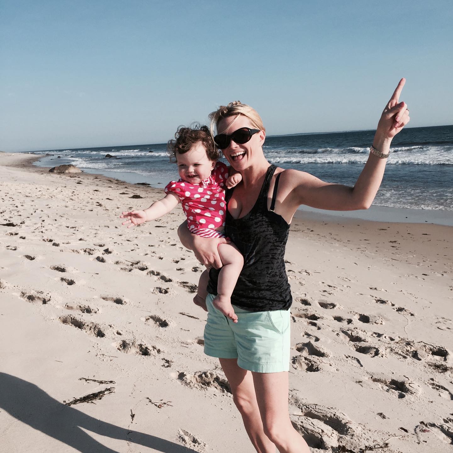 Kelley Wolf with a baby on the beach. 