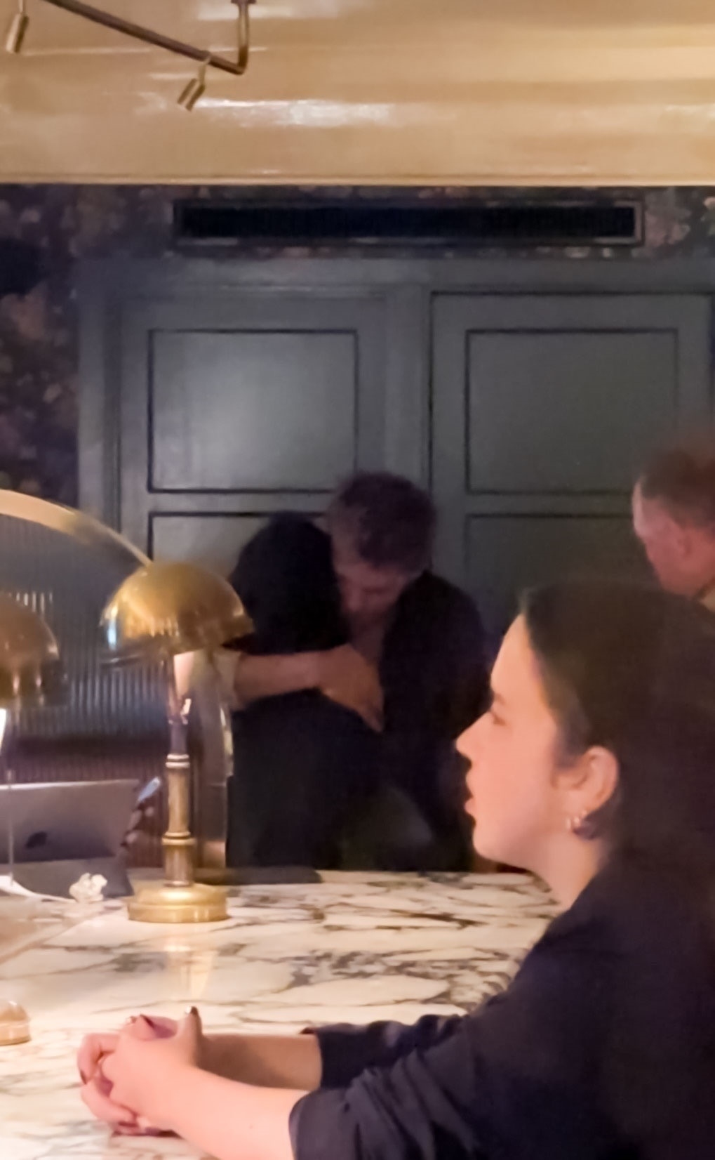 Austin Butler and Zoe Kravitz hug in a bar. 