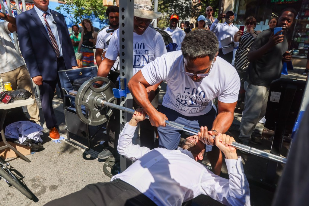Zohran Mamdani bench pressing during a campaign event in Brooklyn.
