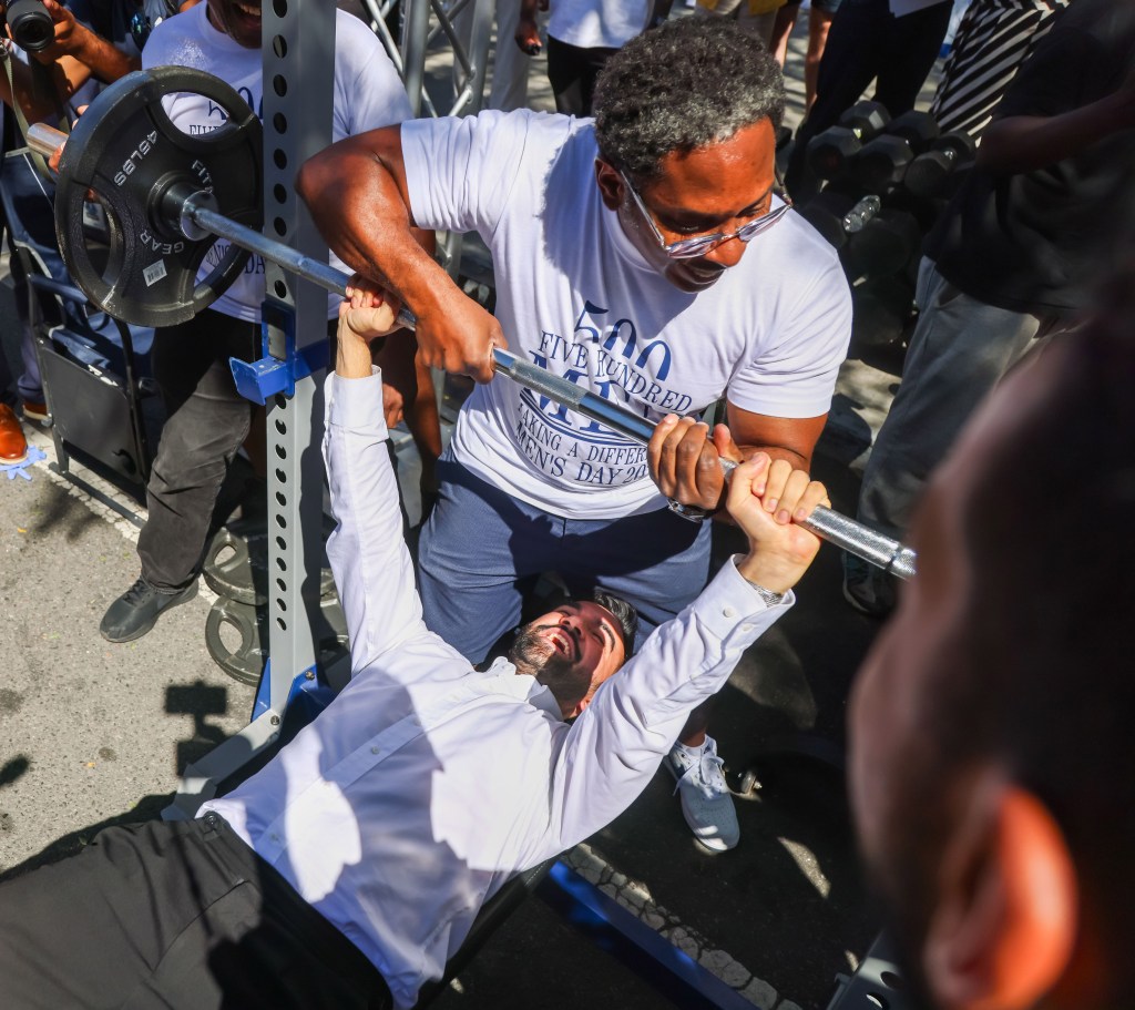 Zohran Mamdani bench pressing during a campaign event in Brooklyn.