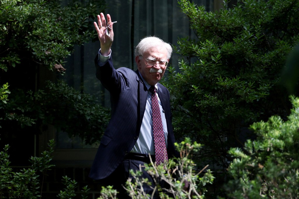 John Bolton waving after an FBI search of his home.