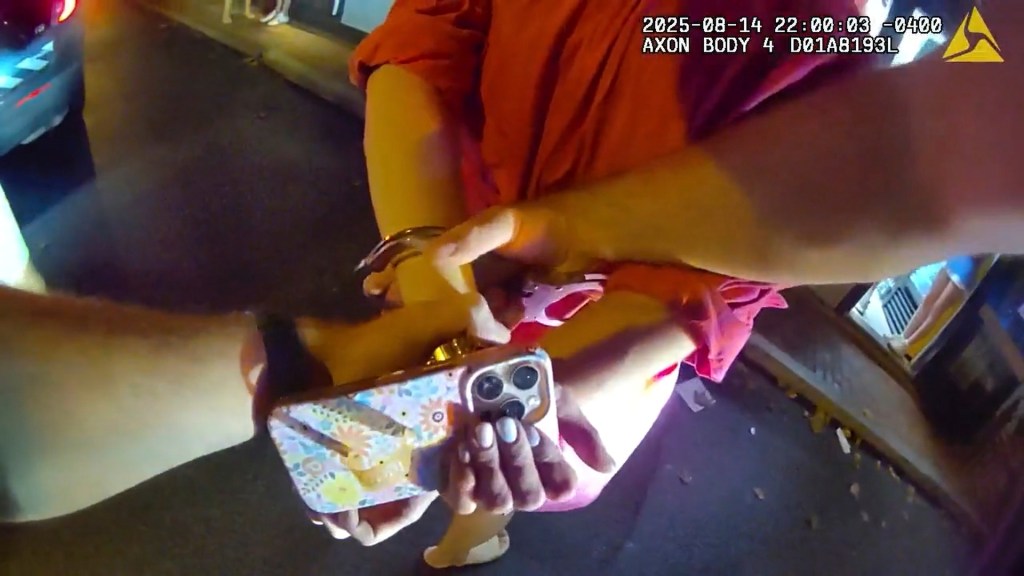 Police officer handcuffing Devon Flanagan.