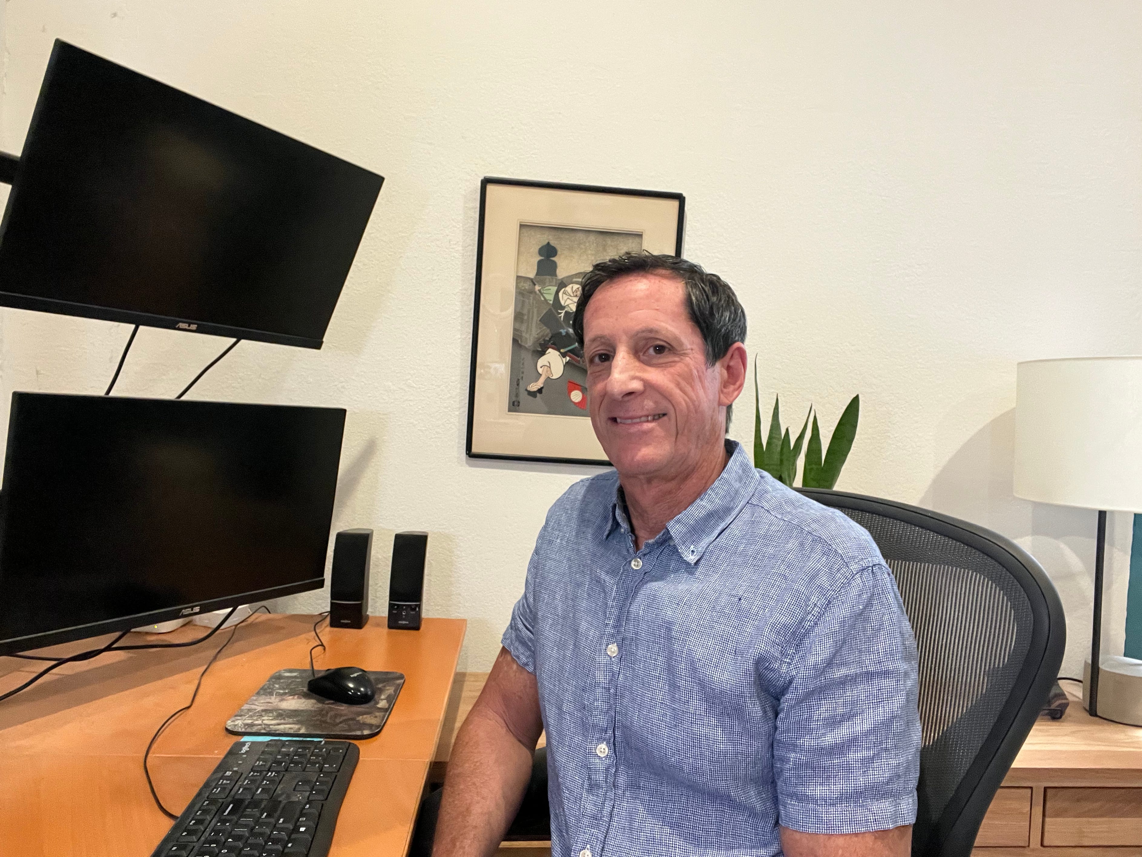 Photo of Andrew Menaker at his desk