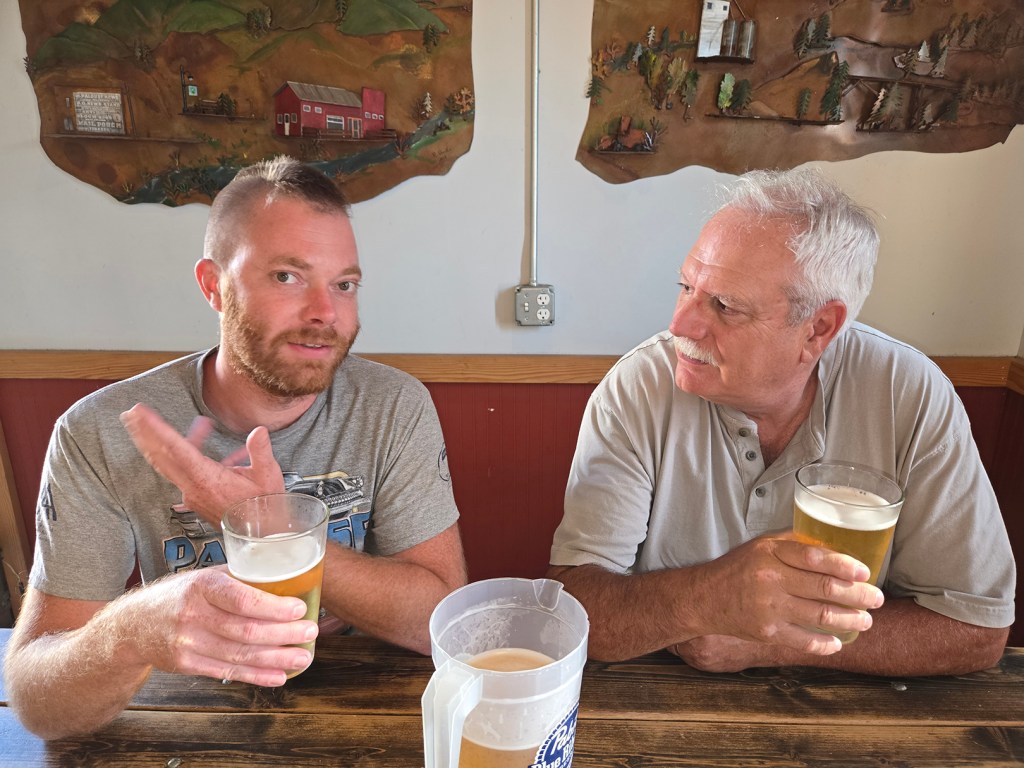 Two men enjoying beers together.