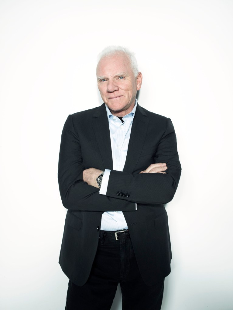 Malcolm McDowell standing.