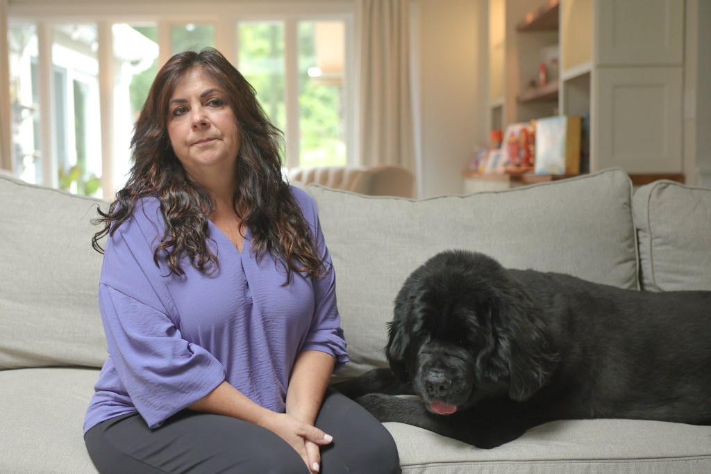 Karen Freed and her dog Kyra sitting on a couch.
