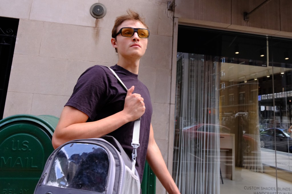 Mingus Lucien Reedus carrying a pet carrier.