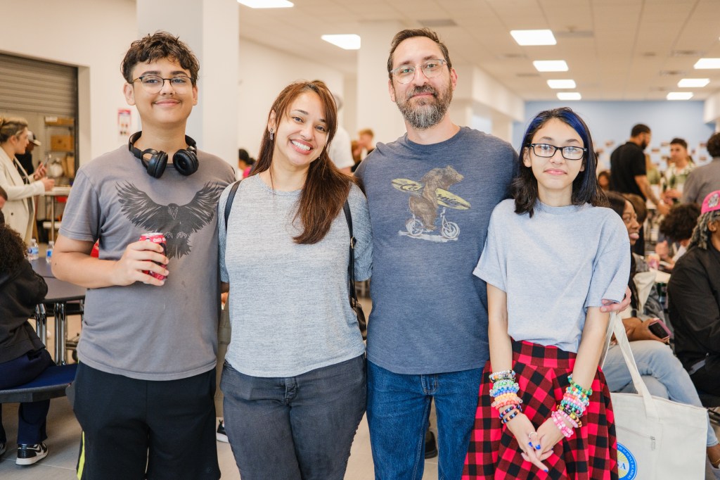 Family posing at MESA South Brooklyn charter high school opening.