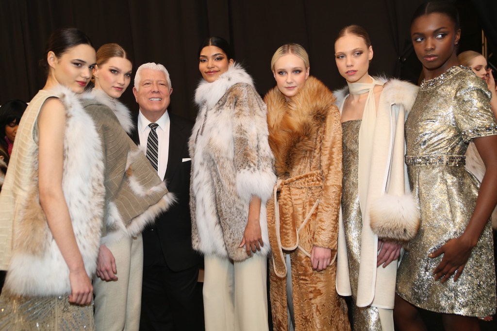 Dennis Basso with models backstage at a fashion show.