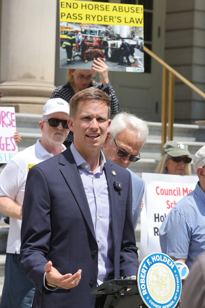Protest at NYC City Hall advocating for Ryder's Law to end the horse carriage industry.