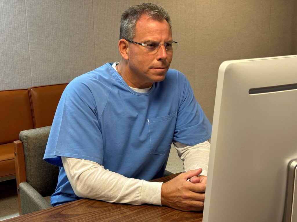 Erik Menendez participating in a parole hearing via video conference.