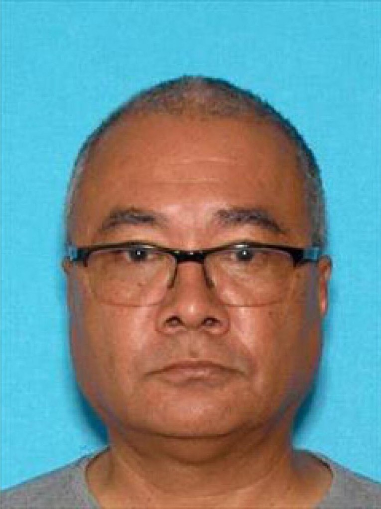 Mugshot of a man wearing glasses.