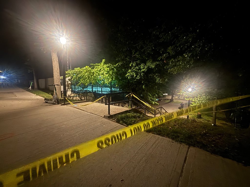 Crime scene at night with police tape.