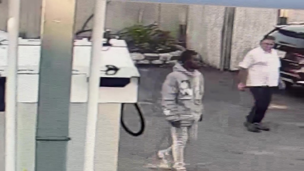 Security camera footage of a man attempting to steal a car.