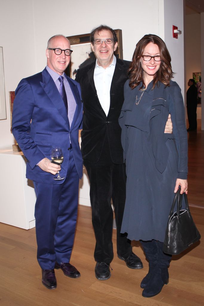 Three people at an art event.