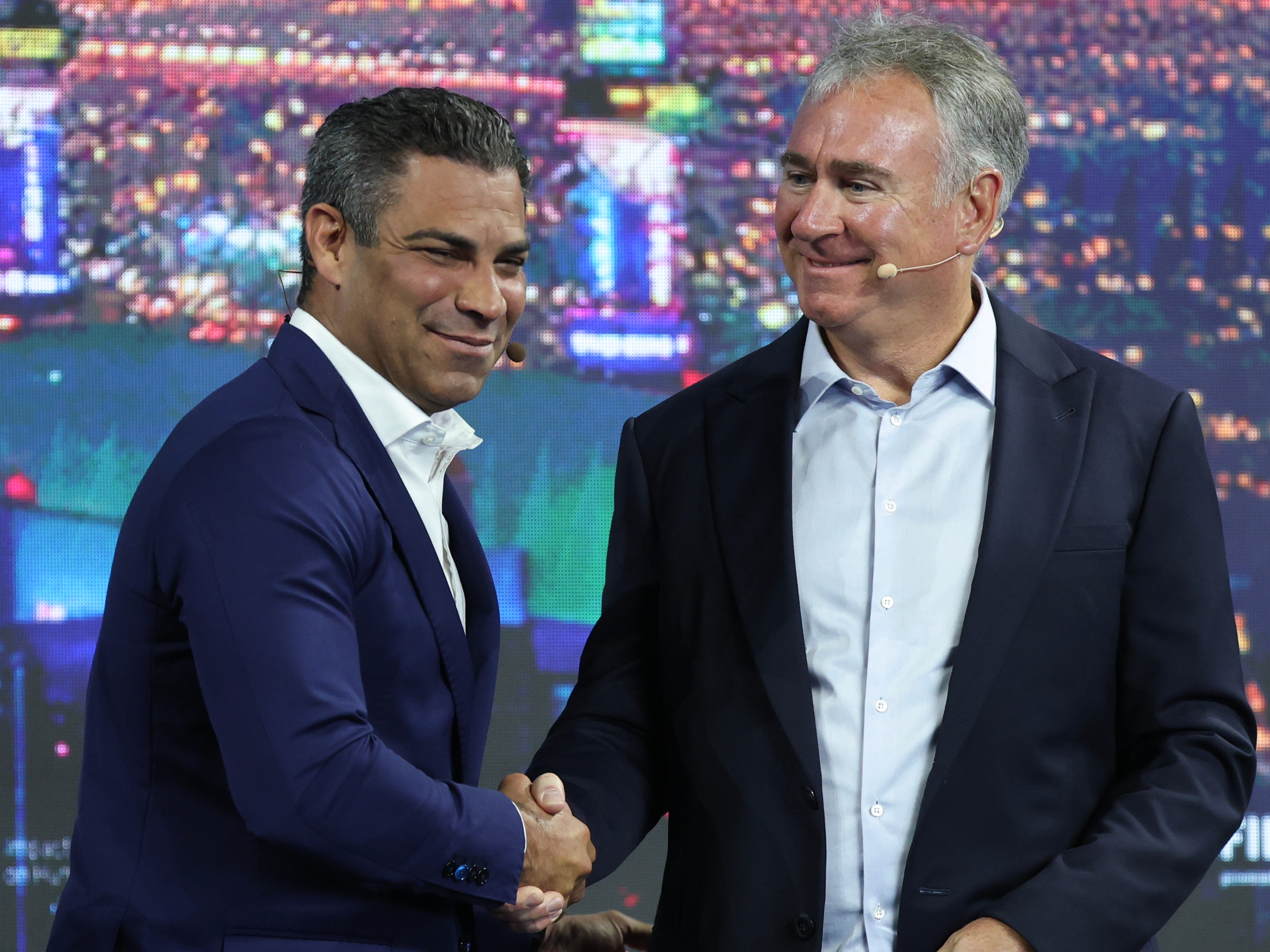 Mayor Francis Suarez of Miami and Kenneth Griffin shaking hands at a conference.