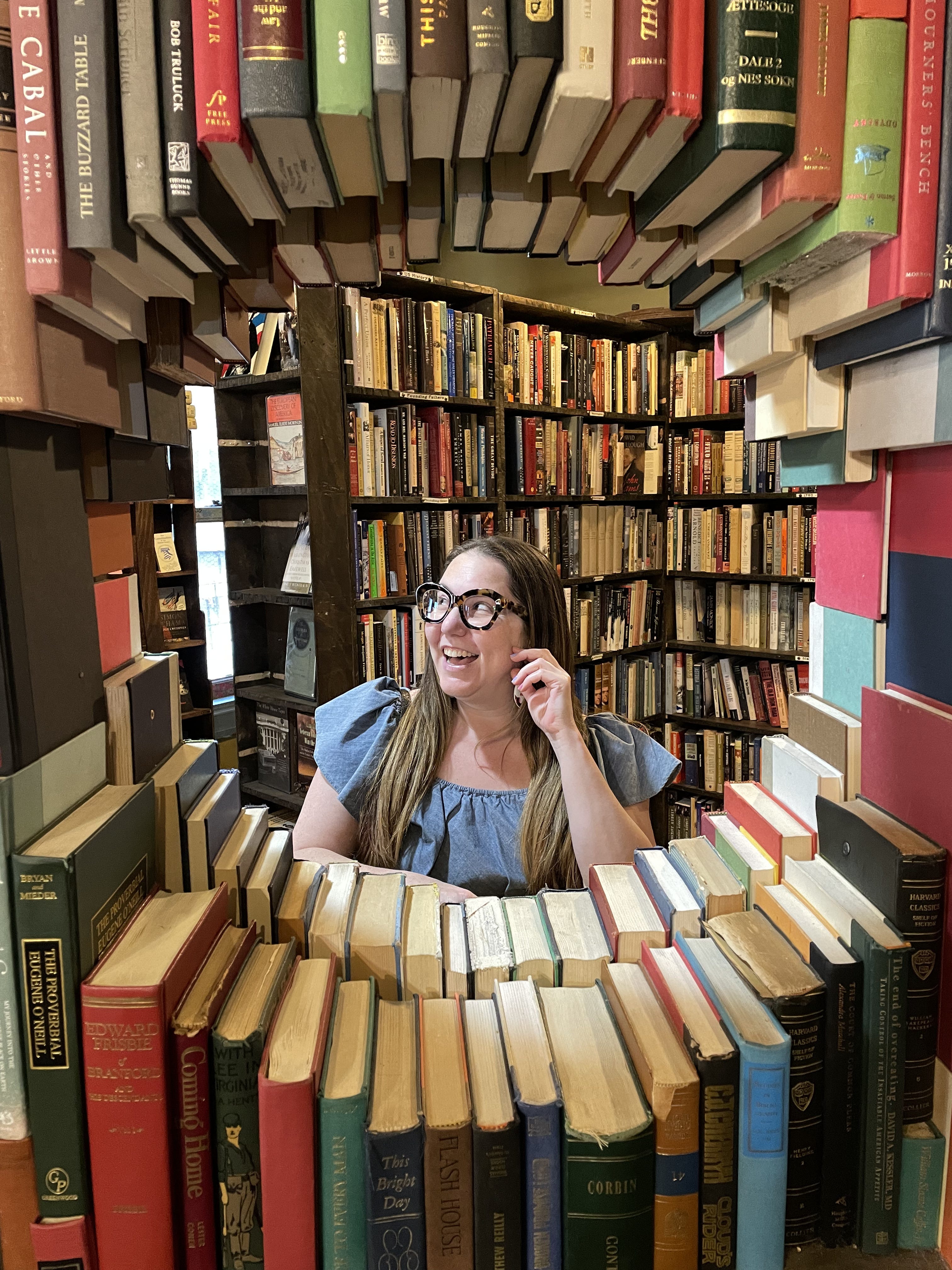woman surrounded by books in a book store