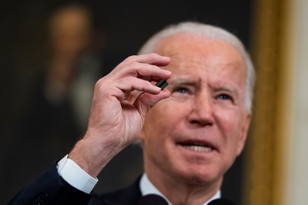 President Biden holding a semiconductor.