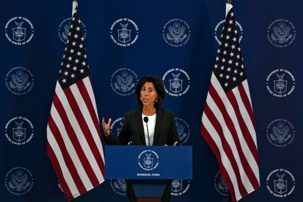 Secretary Raimondo speaking at a podium in Shanghai.