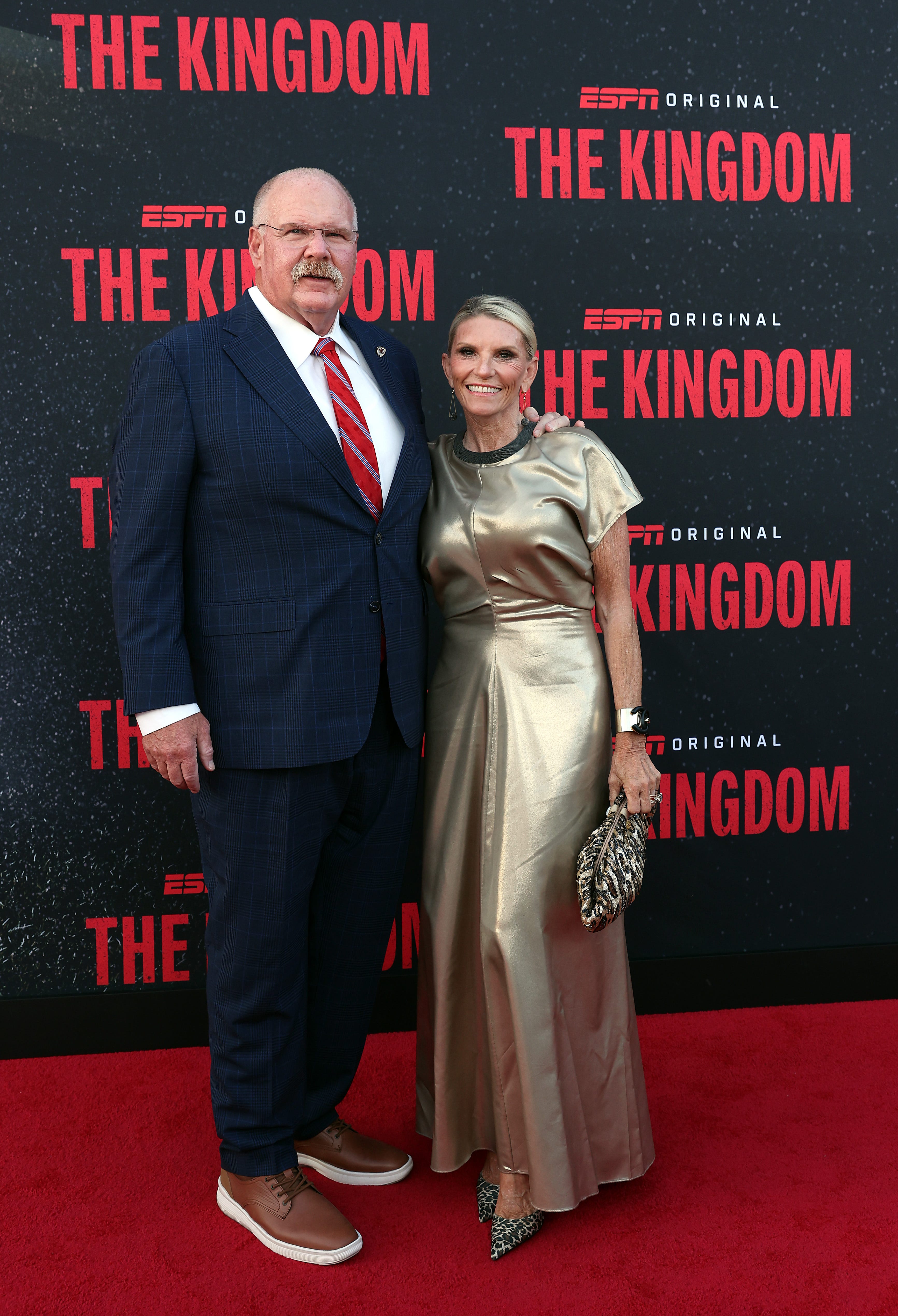 Andy Reid and Tammy Reid embrace on the red carpet at a screening of "The Kingdom."