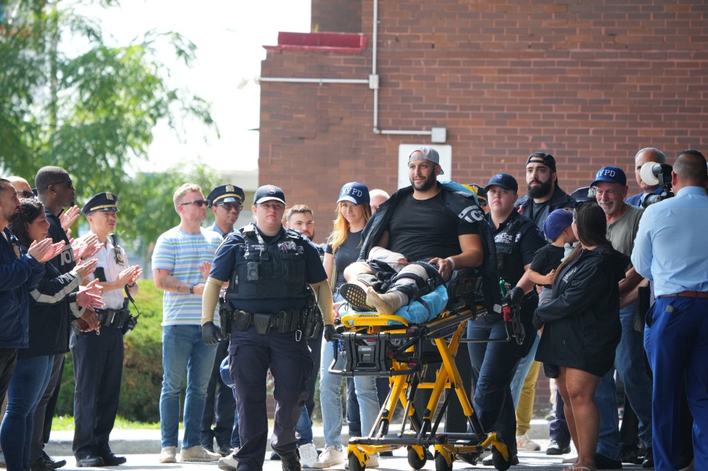 NYPD Detective Corey Fisher being released from the hospital after a carjacking incident.