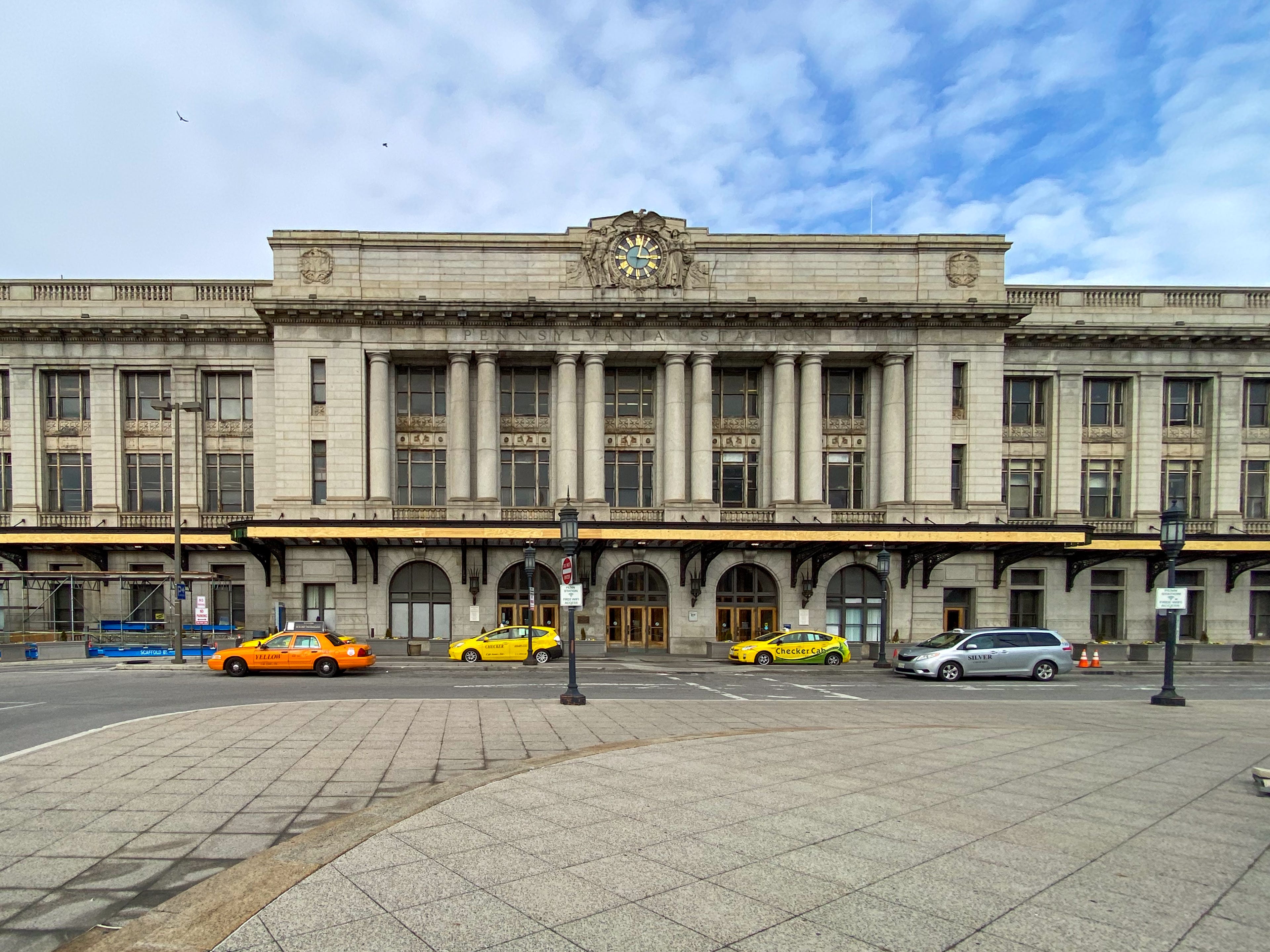 The exterior of Baltimore's Penn Station with taxis parked in front