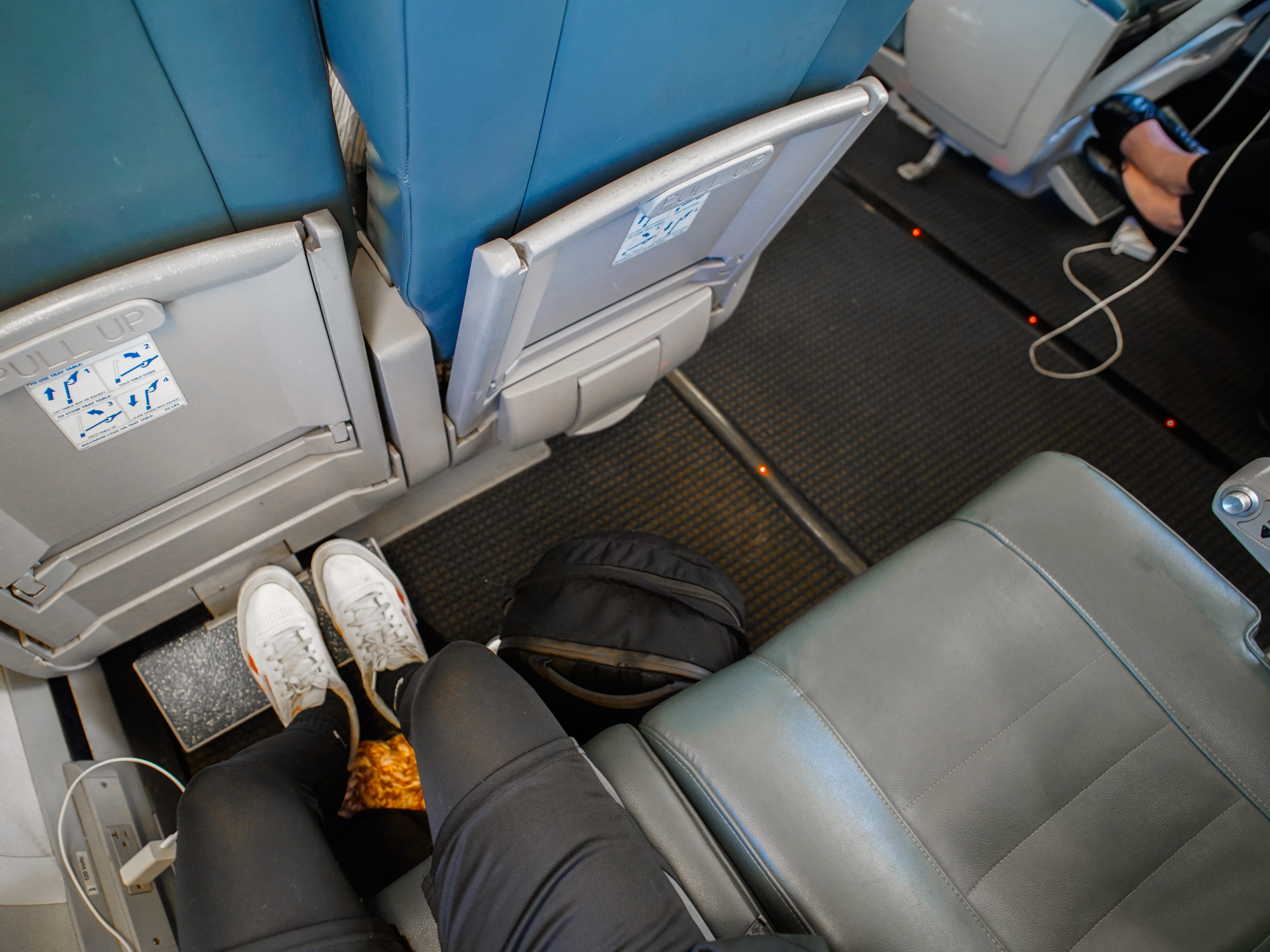 An aerial view of the author sitting in her business-class seat