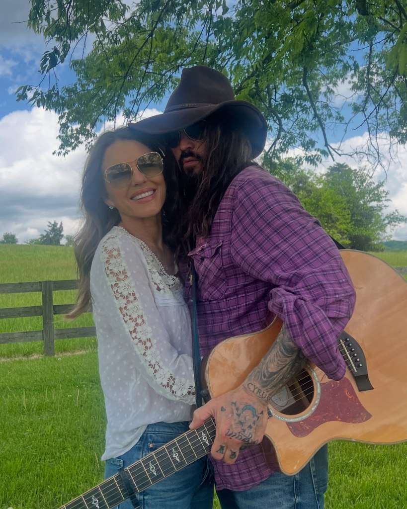 Elizabeth Hurley poses with Billy Ray Cyrus.
