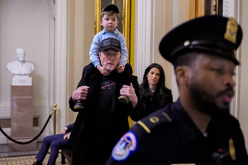 Elon Musk and his son X Æ, accompanied by White House Deputy Chief of Staff Stephen Miller's wife, Katie Miller (2nd-R), a top adviser and spokesperson for the Department of Government Efficiency arrive for a meeting with Senate Committee on Commerce, Science, and Transportation members at the U.S. Capitol Building on May 21, 2025 in Washington, DC. According to a representative, Musk was attending the meeting as CEO of artificial intelligence company xAI to discuss topics unrelated to the Department of Government Efficiency (DOGE).