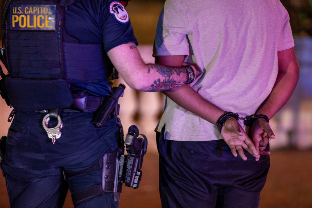 A U.S. Capitol Police officer arresting a man.
