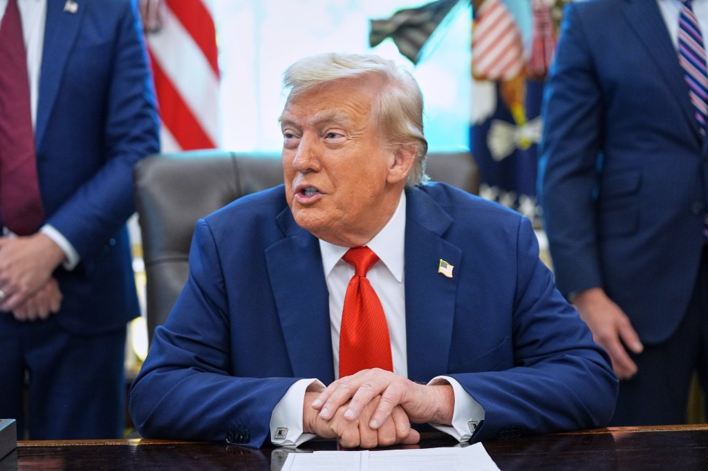 Donald Trump speaking at a table.