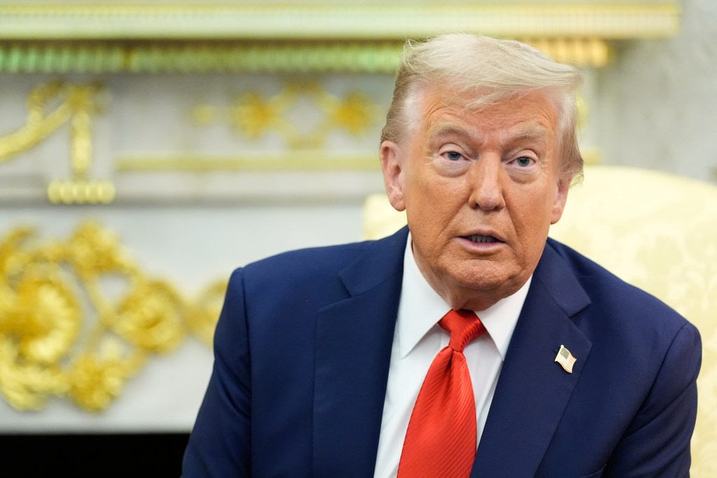 Donald Trump in a navy blue suit and red tie.