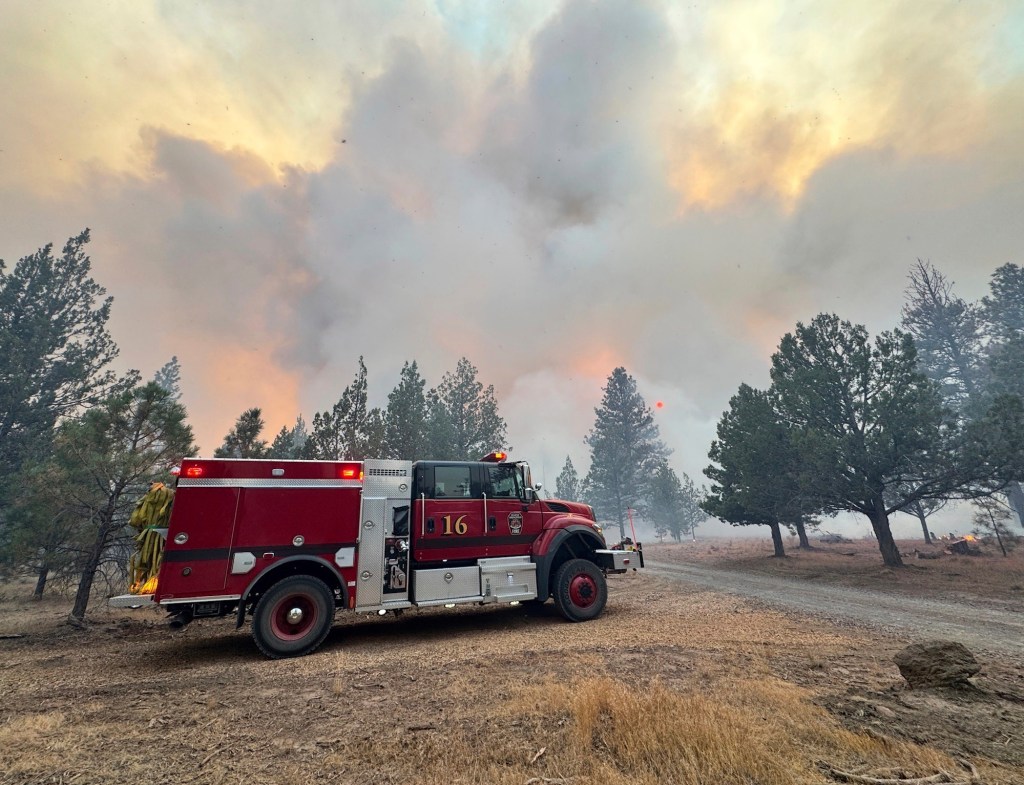 Firetruck at wildfire scene.