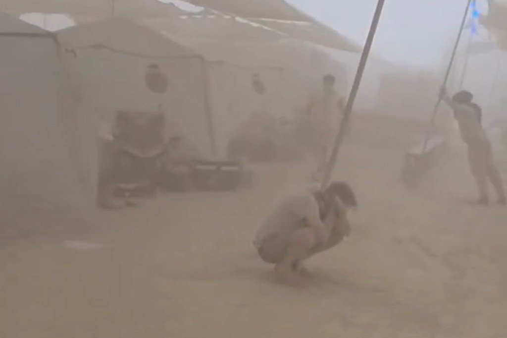 People taking cover from a dust storm.