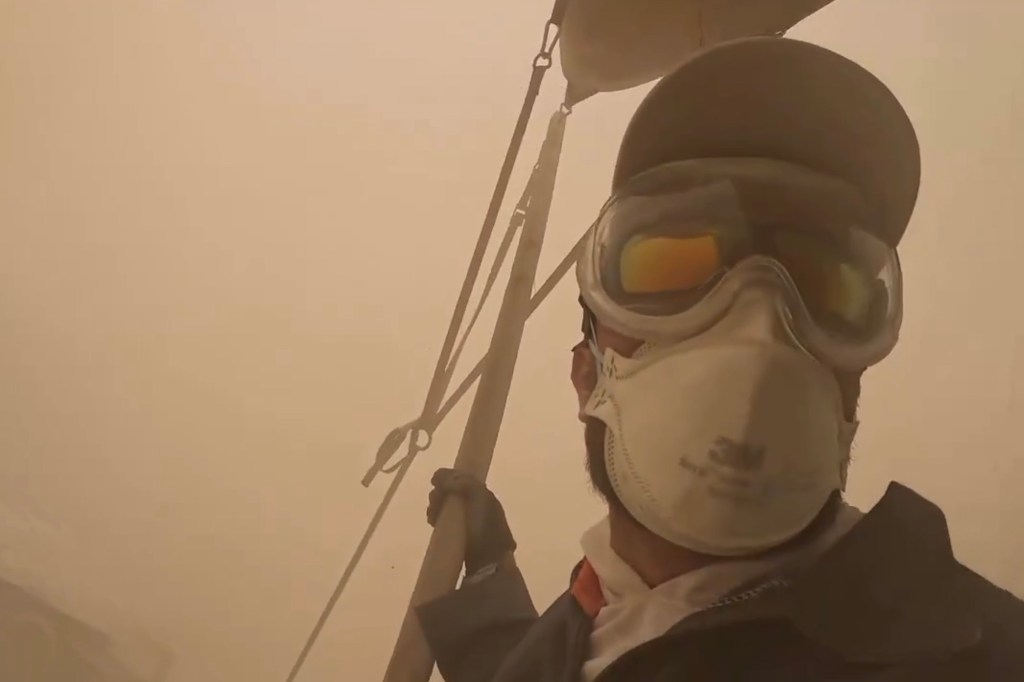 Person wearing protective gear in a dust storm.