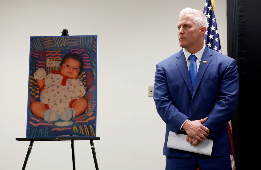 Jeff Reisig at a press conference, next to a photo of Kato Krow Perez.