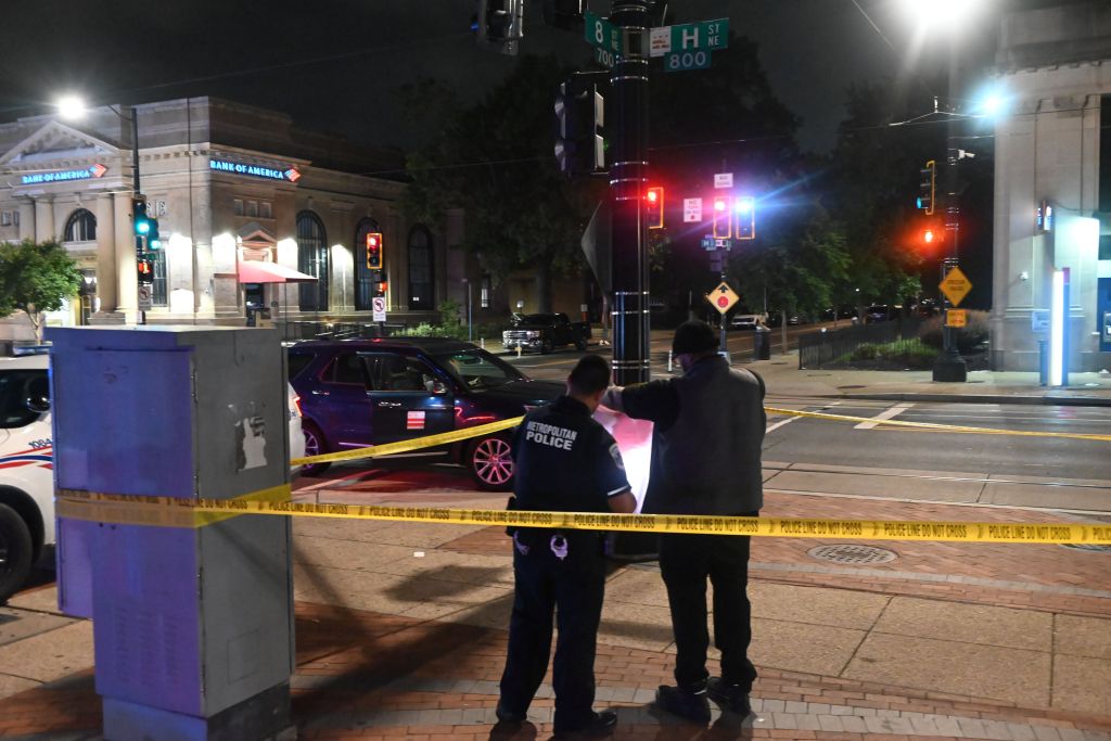 Metropolitan Police Department officers work the crime scene where a stabbing leaves a person with injuries