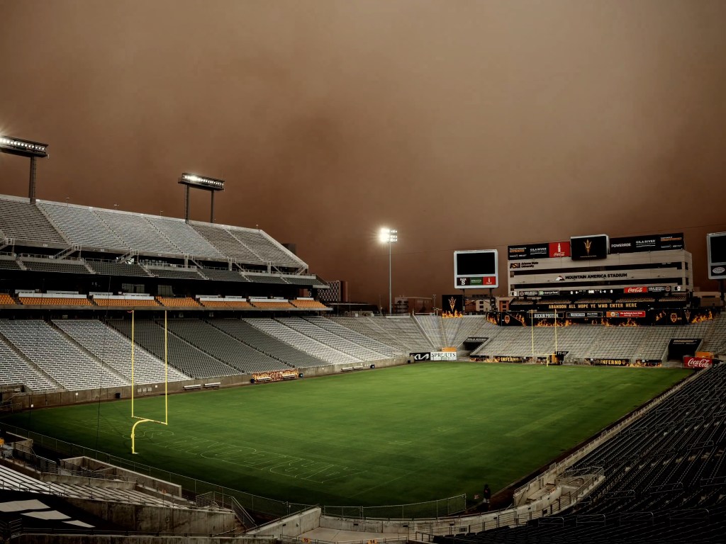 Mountain America Stadium enveloped in a dust storm.