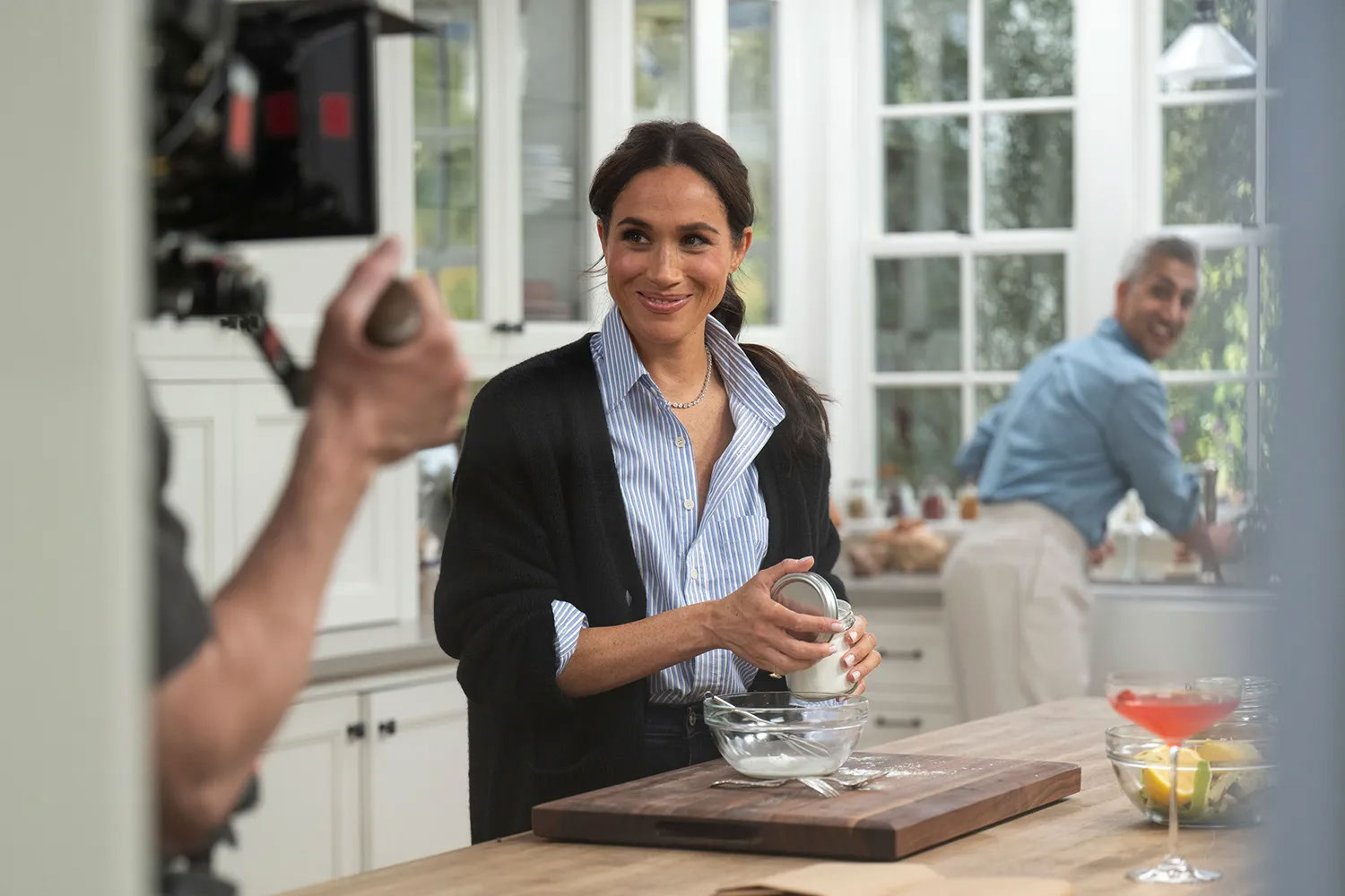Meghan Markle smiles in a kitchen. 