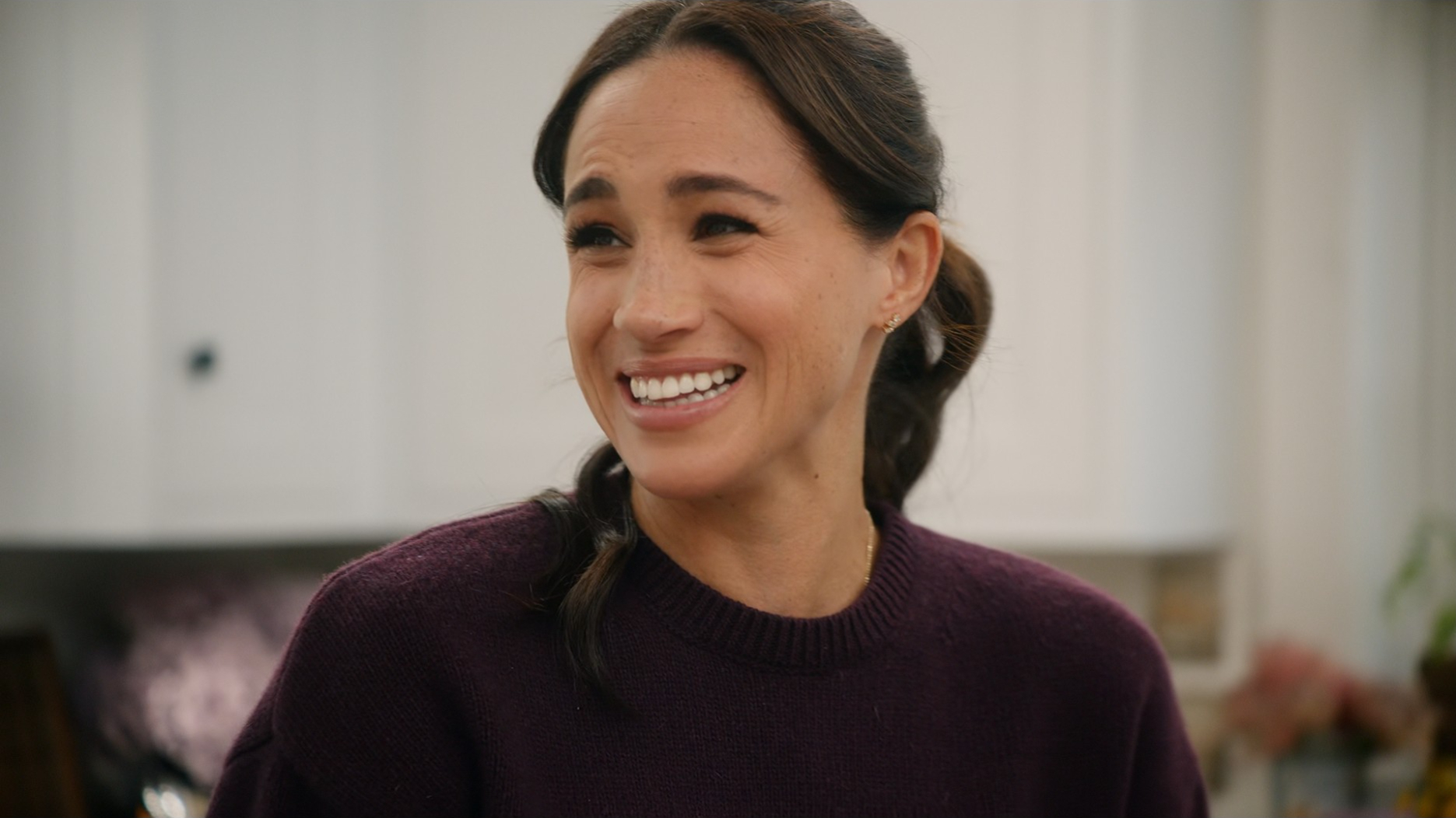 Meghan Markle smiles.