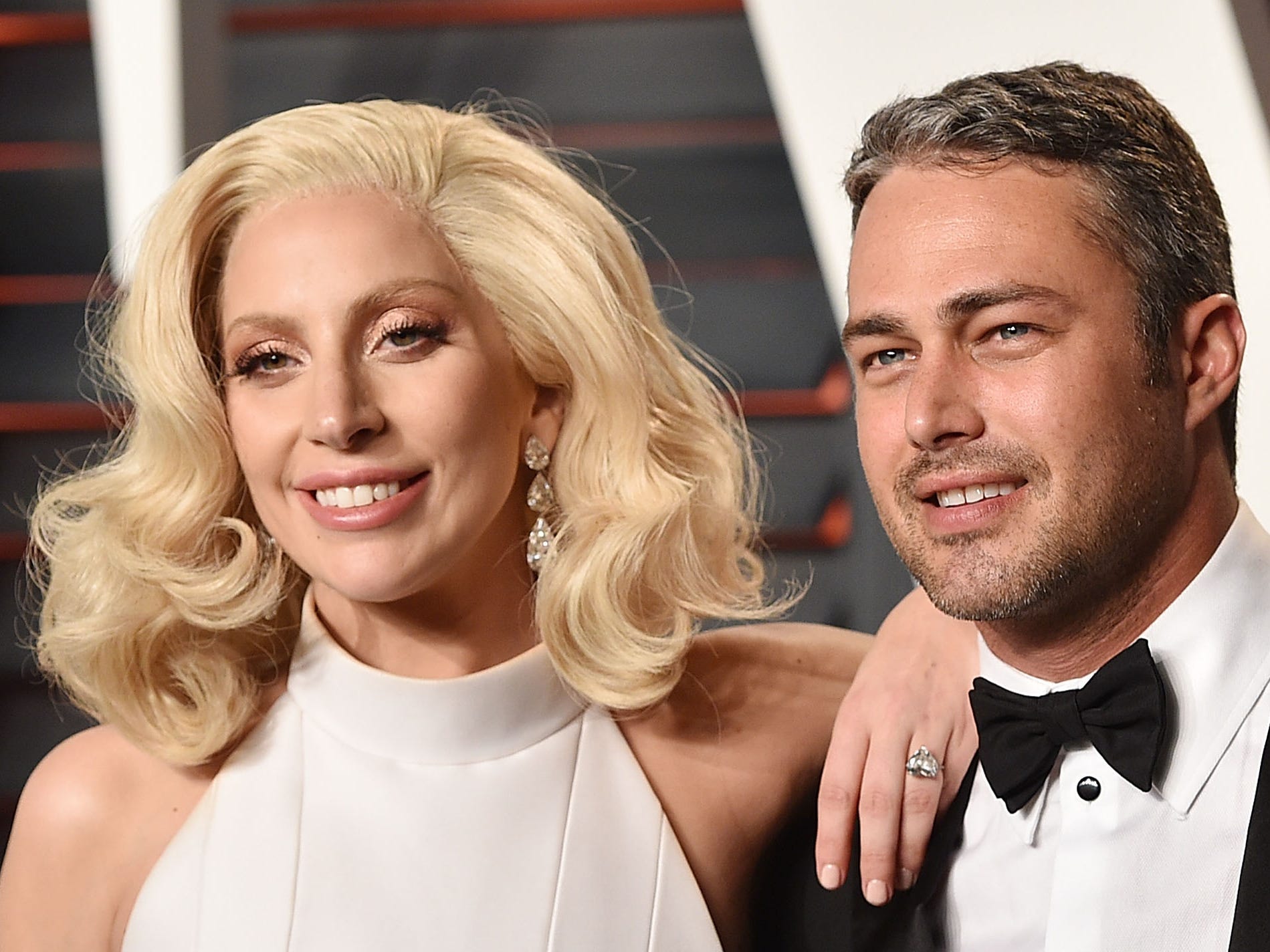 Lady Gaga and Taylor Kinney posing at the 2016 Vanity Fair Oscar Party.