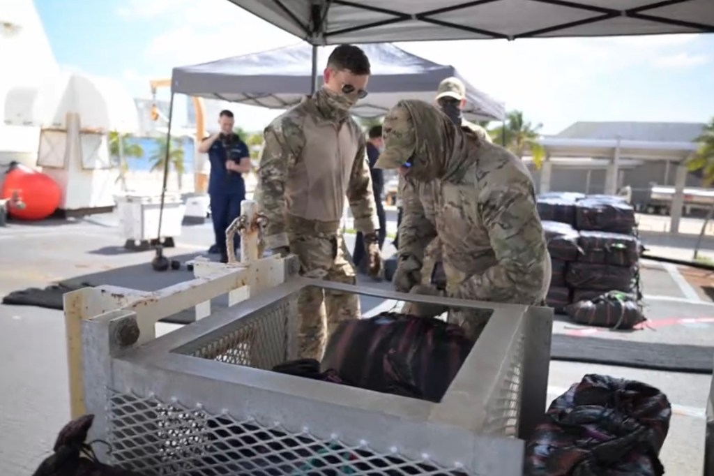 Coast Guard personnel inspecting seized packages.