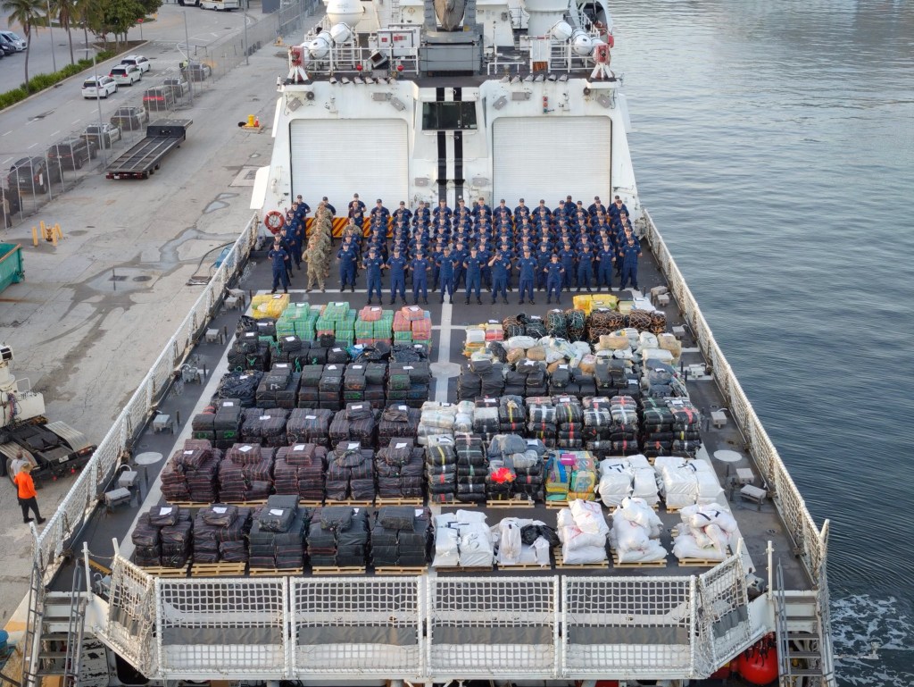 Coast Guard crew standing on deck with confiscated drugs.