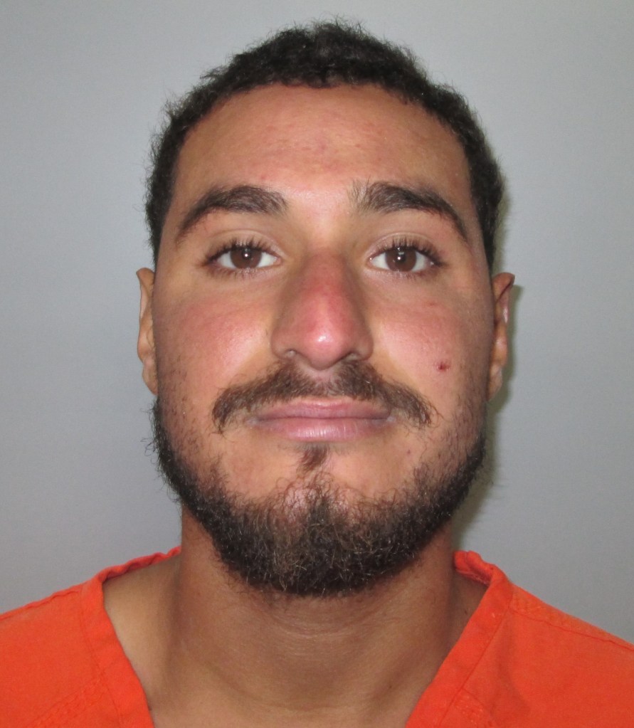Mugshot of a man in an orange jumpsuit.