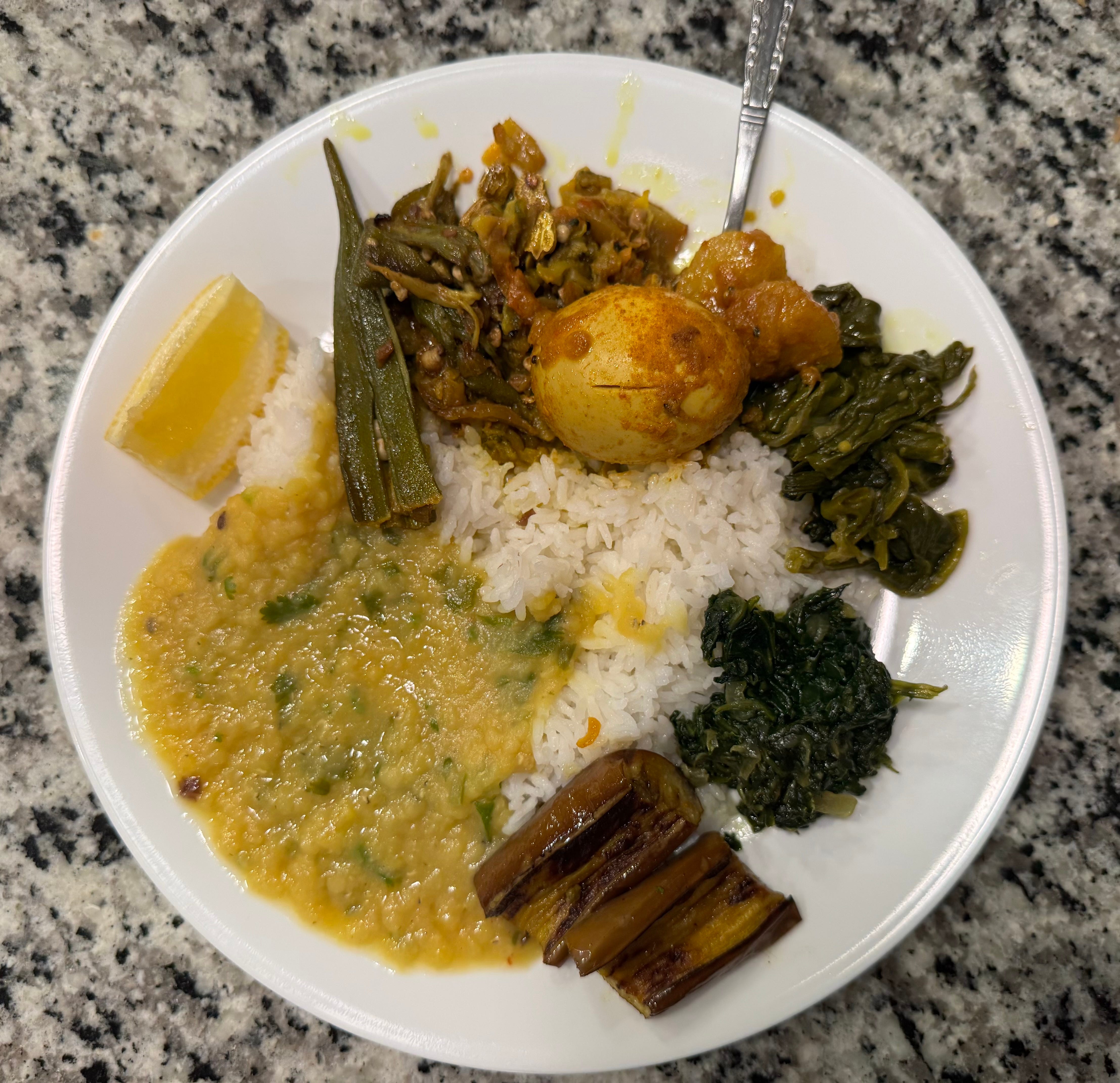 A dinner plate filled with Indian food.